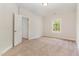 Neutral bedroom showing a single window and doorway, along with beige carpeting at 66 Sweet Meadow Ln, Pittsboro, NC 27312