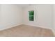 Empty bedroom featuring one window, tan carpeting, and neutral walls at 66 Sweet Meadow Ln, Pittsboro, NC 27312