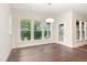 Sunlit dining area features hardwood floors, large windows, and a sliding glass door to the deck at 66 Sweet Meadow Ln, Pittsboro, NC 27312