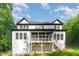 Rear exterior featuring a large deck, stairs to the yard, and daylight basement access at 66 Sweet Meadow Ln, Pittsboro, NC 27312