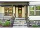 Inviting front porch with stone steps and iron railings, offering curb appeal at 66 Sweet Meadow Ln, Pittsboro, NC 27312