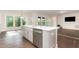 Bright kitchen with quartz counters, stainless appliances and large windows overlooking treed backyard at 66 Sweet Meadow Ln, Pittsboro, NC 27312