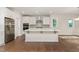 New kitchen with island, stainless appliances, quartz countertops, and dark wood flooring at 66 Sweet Meadow Ln, Pittsboro, NC 27312