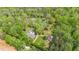 Aerial view of the property showcasing the house, pool, outbuildings, and surrounding lush, green landscape at 6971 Shady Creek Trl, Rougemont, NC 27572