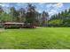 Expansive backyard featuring a red barn and lush green lawn at 6971 Shady Creek Trl, Rougemont, NC 27572