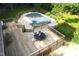 A large wooden deck offers ample space for outdoor dining and relaxation with view of the covered in ground pool at 6971 Shady Creek Trl, Rougemont, NC 27572