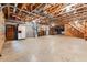 Spacious unfinished basement with exposed ceiling, concrete floor, and utility systems, offering potential for customization and additional space at 6971 Shady Creek Trl, Rougemont, NC 27572