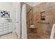Accessible bathroom features tiled shower with bench and safety bars, and a storage cabinet for added convenience at 6971 Shady Creek Trl, Rougemont, NC 27572