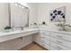 Elegant bathroom with a vanity featuring a sleek countertop, ample storage, and a stylish mirror creating a bright and inviting space at 6971 Shady Creek Trl, Rougemont, NC 27572