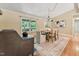 Bright dining room with wood floors, a charming light fixture, and a view to the backyard, perfect for entertaining at 6971 Shady Creek Trl, Rougemont, NC 27572