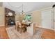 Cozy dining room featuring a stone fireplace, wood floors, and a dining table set for a comfortable meal at 6971 Shady Creek Trl, Rougemont, NC 27572