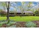 Charming wood-sided home with a lush front lawn, mature trees, and inviting landscaping for exceptional curb appeal at 6971 Shady Creek Trl, Rougemont, NC 27572