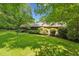 A well maintained single-story home with a lush green lawn, and mature shrubs at 6971 Shady Creek Trl, Rougemont, NC 27572