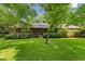 Charming home exterior with mature landscaping and lush green grass, offering a welcoming curb appeal and a serene setting at 6971 Shady Creek Trl, Rougemont, NC 27572