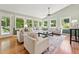 Bright living room with large windows, hardwood floors, and comfortable seating, creating an inviting space at 6971 Shady Creek Trl, Rougemont, NC 27572