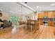 Open-concept living space featuring a modern kitchen, dining area, and cozy fireplace, ideal for Gathering gatherings at 6971 Shady Creek Trl, Rougemont, NC 27572