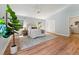 Airy main bedroom featuring wood floors, a comfortable king-size bed, and two bright windows, creating a peaceful retreat at 6971 Shady Creek Trl, Rougemont, NC 27572