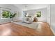 Bright main bedroom with hardwood floors, large windows, and a comfortable bed, creating a serene retreat at 6971 Shady Creek Trl, Rougemont, NC 27572