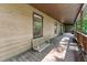 Inviting porch featuring a wooden swing and ample space for relaxation at 6971 Shady Creek Trl, Rougemont, NC 27572