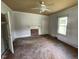 Spacious bedroom featuring a ceiling fan, fireplace and good light at 705 Washington St, Graham, NC 27253