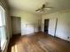 Empty bedroom with wood floors and a non-decorative fireplace at 705 Washington St, Graham, NC 27253