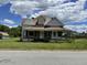 Exterior of home with porch and rustic metal roof at 705 Washington St, Graham, NC 27253