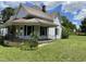 Exterior view of house with covered porch, black railing, and green lawn at 705 Washington St, Graham, NC 27253