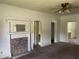 Empty living room features a fireplace, wood trim, and arched doorways at 705 Washington St, Graham, NC 27253
