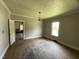 Empty living room features wood floors, neutral walls, and a window with natural light at 705 Washington St, Graham, NC 27253