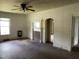 Empty living room features wood floors, a fireplace, and arched doorways to other rooms at 705 Washington St, Graham, NC 27253