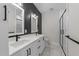 Elegant bathroom with double vanity, sleek black fixtures, and a modern glass shower at 710 W North St # 101, Raleigh, NC 27603
