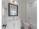 Well-lit bathroom featuring a vanity, mirror, shower over tub, and toilet at 710 W North St # 101, Raleigh, NC 27603