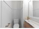 Stylish half bathroom with modern fixtures, wood accents and white trim at 710 W North St # 101, Raleigh, NC 27603