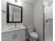 Modern bathroom with a stylish vanity, mirror, glass shower, and white tiling at 710 W North St # 101, Raleigh, NC 27603