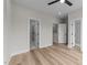 Bright bedroom featuring a ceiling fan, wood flooring and an ensuite bathroom with a glass shower at 710 W North St # 101, Raleigh, NC 27603