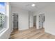 Sunlit bedroom with wood floors, featuring views to the outside and an ensuite bathroom at 710 W North St # 101, Raleigh, NC 27603