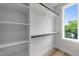 Walk-in closet offers ample storage with custom shelving and views to the outside at 710 W North St # 101, Raleigh, NC 27603