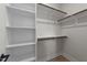 Spacious walk-in closet featuring multiple shelving areas and wooden racks for storage at 710 W North St # 101, Raleigh, NC 27603