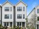 Charming townhome exterior with modern architecture, landscaped front yard, and inviting entrance with stylish doors at 710 W North St # 101, Raleigh, NC 27603