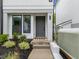 Inviting front entrance with a stylish gray door, modern house numbers and lush landscaping at 710 W North St # 101, Raleigh, NC 27603