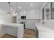 Bright, modern kitchen featuring white cabinets, stainless steel appliances, and an island at 710 W North St # 101, Raleigh, NC 27603