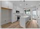 Bright, modern kitchen featuring white cabinets, stainless steel appliances, and an island at 710 W North St # 101, Raleigh, NC 27603