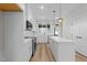 Bright, modern kitchen featuring white cabinets, stainless steel appliances, and an island at 710 W North St # 101, Raleigh, NC 27603