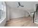 Spacious living room with hardwood floors, modern light fixtures, and staircase access at 710 W North St # 101, Raleigh, NC 27603