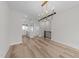 Open-concept living room with hardwood floors, modern light fixtures, and a view of the kitchen at 710 W North St # 101, Raleigh, NC 27603