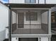 Cozy screened-in porch with black railings, fan, and dark trim at 710 W North St # 101, Raleigh, NC 27603