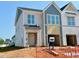 New construction of two-story townhome with attached garage and gray and white siding at 75 Ripple Way # 216, Clayton, NC 27520