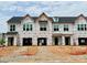 New construction townhomes featuring modern design and spacious garages awaiting personalization at 75 Ripple Way # 216, Clayton, NC 27520