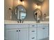 Elegant bathroom features a double vanity with quartz countertops, modern lighting, and sleek black fixtures at 80 Water Willow Ln, Zebulon, NC 27597