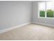 Bright bedroom featuring a neutral color palette, plush carpet, and a large window offering natural light at 80 Water Willow Ln, Zebulon, NC 27597